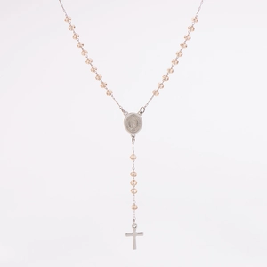 Macro view of champagne beaded necklace with Virgin Mary medal and silver cross pendant