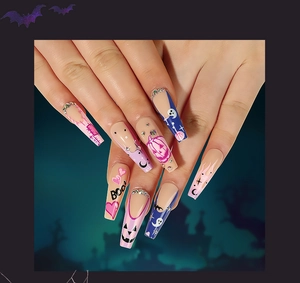 Macro detail of coffin press-on nails with Halloween pumpkin, ghost, and BOO lettering