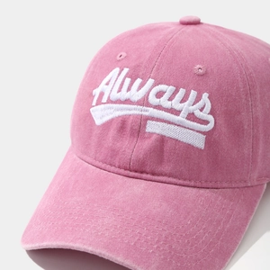 Close-up of pink washed cotton baseball cap featuring 3D Always embroidery detail