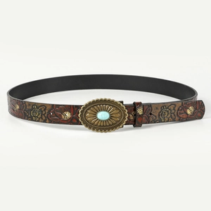 Close-up of bohemian brown leather belt with floral embossing and turquoise buckle