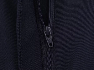 Detail of dark blue twill fabric and durable metal zipper on a women's fashion suit