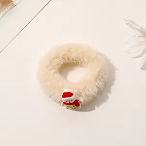 Detail of plush cream hair scrunchie featuring a cute 3D Christmas snowman with red hat