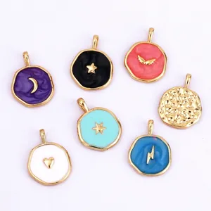 Macro shot of colorful enamel round charms set with gold moon and star patterns