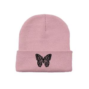Pink knit beanie hat with black butterfly embroidery on the cuff for y2k street style