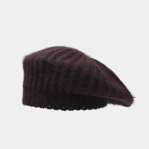 Detail of dark brown rabbit fur knit beret showing textured ribbed pattern and fuzzy fibers