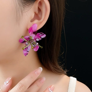 Detailed close-up of a vintage purple flower earring featuring colorful beaded center