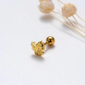 Macro shot of gold-plated X-shaped stud earring with a secure spherical screw back