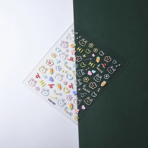 Macro detail of 5D embossed nail stickers featuring cute rabbits and carrot patterns