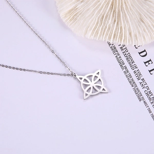 Detailed view of silver Celtic knot compass pendant with polished hollow geometric design