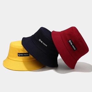 Fashionable cotton bucket hats in yellow, navy, and red with The Focus embroidery