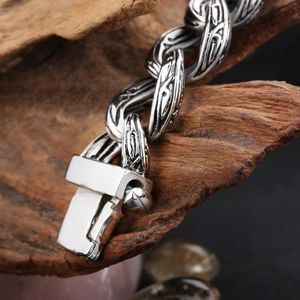 Macro close-up of vintage steel chain links with intricate carved stripe details