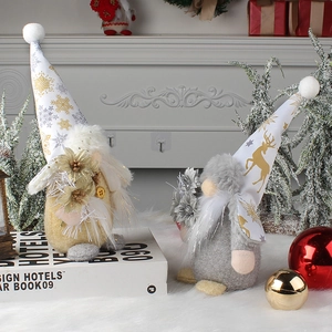 Standing Christmas gnomes in gold and silver with snowflake and elk patterns on hats