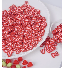 Macro detail of miniature polymer clay strawberry slices for DIY crafts and nail art