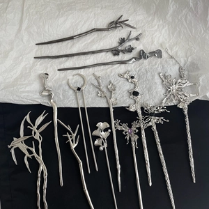 Detailed collection of vintage metallic hair sticks with floral and bamboo motifs