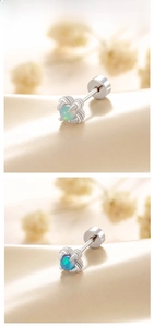 Detail of titanium steel dragon claw earrings with green and blue opal stones