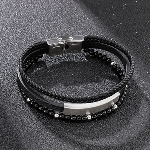 Detail of multi-layer men's leather bracelet with steel buckle and black beads