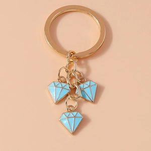 Detail of gold keychain featuring three sky blue diamond-shaped pendants with oil drip finish