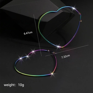 Macro detail of large iridescent heart-shaped titanium steel hoop earrings with rainbow finish