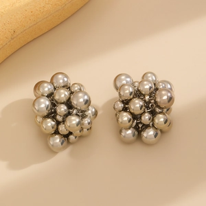 Macro view of cluster earrings with stacked polished silver spheres and mirror finish