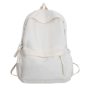 Minimalist cream white waterproof nylon backpack for students and travel on white background