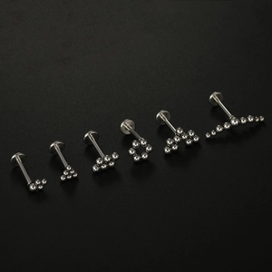 Polished 16G surgical steel labret stud set with various metal bead cluster designs