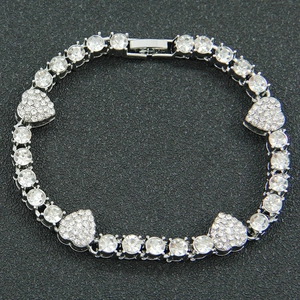 Silver hip hop Cuban link heart bracelet with clear rhinestones on black background