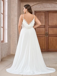 Close-up of delicate lace embroidery on backless white chiffon maxi wedding dress