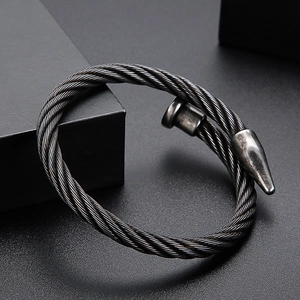 Macro detail of industrial steel cable nail bracelet with vintage black finish