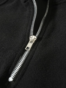 Close-up of premium silver metal zipper on black fleece pullover with sharp macro detail
