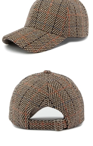 Detailed view of brown herringbone tweed baseball cap with adjustable metal strap buckle