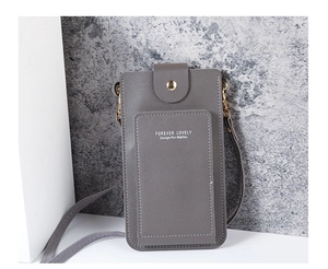 Close-up of grey leather crossbody phone bag with gold buckles and stitched card slot