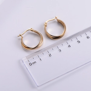 Detailed view of layered gold hoop earrings with ruler showing 2.5cm to 3cm diameter size