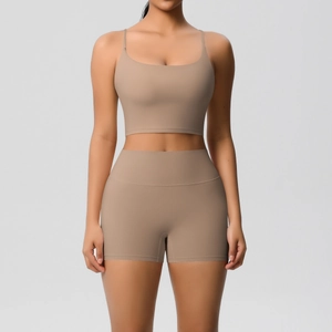 Detail of high-stretch khaki yoga set featuring thin strap camisole and high-waist shorts
