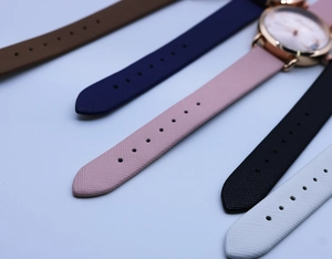 Macro shot showing diverse leather strap textures and rose gold watch cases