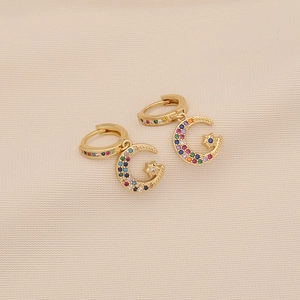 Detailed close-up of crescent moon and star earrings with colorful pavé zircon stones