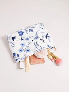 Trousse de maquillage en lin brodé avec motifs floraux bleus et fermeture dorée