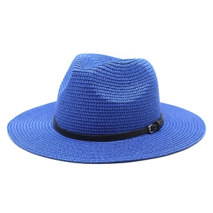 Detail of bright blue straw sun hat with fine weave texture and black leatherette band
