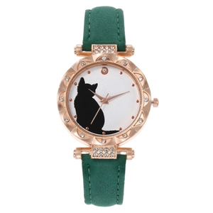 Close-up of rose gold cat watch with emerald green leather strap and crystal bezel