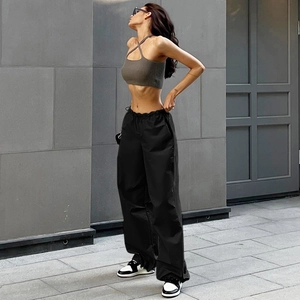 Détail du pantalon cargo noir à cordon avec un haut licou marron de style urbain