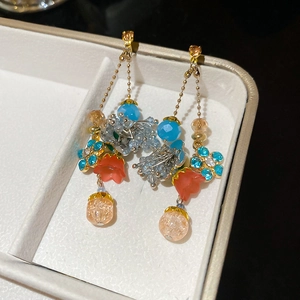 Detail shot of vintage crystal flower tassel earrings with blue and champagne beads