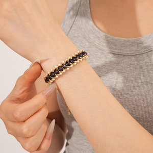 Detail of vintage beaded bracelet featuring purple crystals and white pearls on wrist