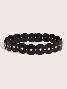 Close-up of black leather heart patchwork belt with metallic rivets in western retro style