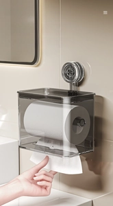 Detail of grey transparent wall-mounted tissue box with large caliber smooth paper output