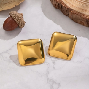 Polished 18K gold plated stainless steel square stud earrings on marble background