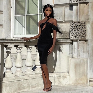 Elegant black cutout one-shoulder bodycon dress with midi length in architectural setting