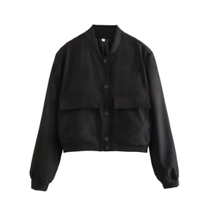 Flat lay macro view of the stand-up collar and size S tag on this black cropped jacket