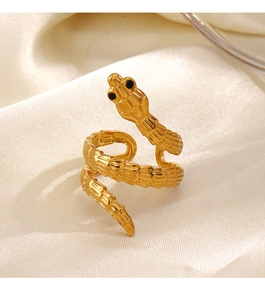 Golden snake wrap ring displayed on beige silk fabric showing elegant metallic texture
