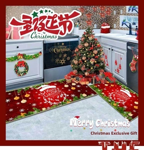 Detail of red Christmas kitchen mats set with Merry Christmas text and reindeer