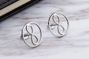 Detailed view of silver round stud earrings featuring an infinity symbol cutout design