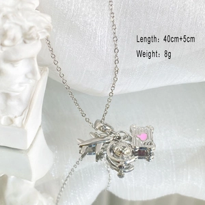 Detailed shot of titanium steel necklace featuring airplane and suitcase charms